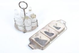 A silver-plated oval cruet stand and six clear cut glass bottle and a serving trap with three cut