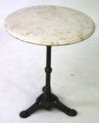 A marble top pub table with cast metal tripod base.