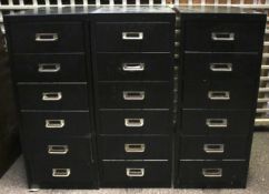 Three multi-drawer filing cabinets.