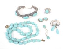 A collection of turquoise jewellery including a far eastern oval cabochon three stone panel