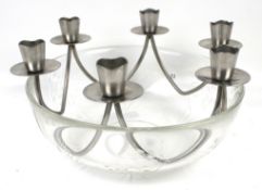 An Orrefors glass bowl and a stainless steel candle holder.