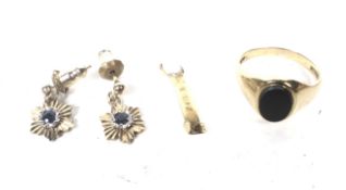 A vintage 9ct gold and black onyx oval signet ring and a pair of earrings.