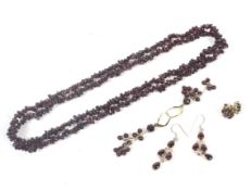 A small collection of garnet jewellery including a tumble-polished abstract-bead necklace.