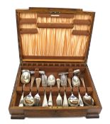 A vintage oak canteen of flatware. Comprising forks and spoons only.