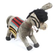 A large vintage Merrythought donkey. Straw filled, complete with bells and blanket.