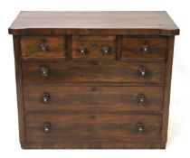 A mahogany veneered chest of drawers.