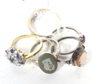 A group of five lady's silver and yellow metal rings including a sapphire;