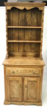 A contemporary oak dresser. A single drawer, two door cupboard beneath and two shelves above.