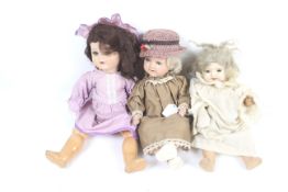A collection of three vintage dolls.