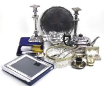 A pair of silver-plated copper shaped-square candlesticks and a collection of plated items.