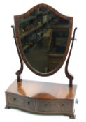 A mahogany Regency shield swing dressing mirror. With two drawers below in the bow front.