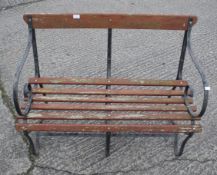 A traditional wraught iron and wood garden bench.