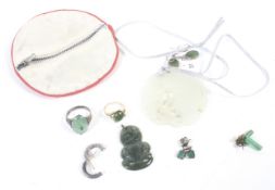 A collection of green hardstone jewellery including a New Zealand nephrite Hei Tiki pendant,