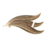 A vintage Italian yellow metal brooch in the form of a quiver of feathers.