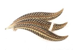 A vintage Italian yellow metal brooch in the form of a quiver of feathers.
