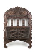 An Anglo- Chinese carved wooden newspaper wall rack.