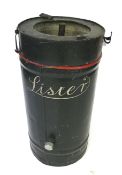 A vintage Lister cylinder water tank in green and red.