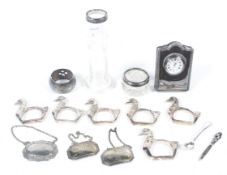 A group of silver and white collectables including hallmarked clock,