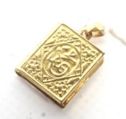A middle Eastern yellow metal book shaped pendant.