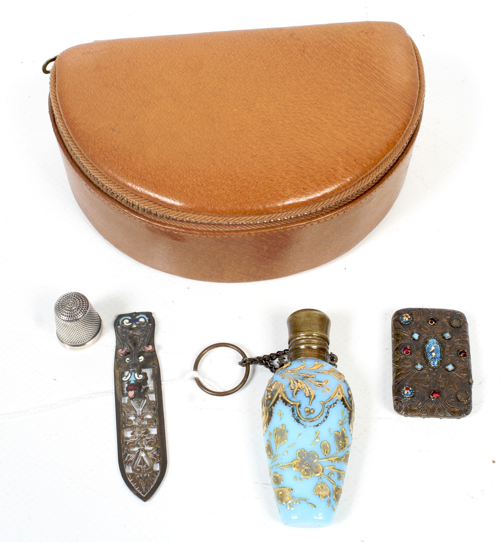 A small group of objects including a pale-blue glass scent bottle.