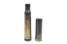 A brass Trench Art lighter and a WWII bullet case. The first marked Eley Kynoch 16 16, total H6.