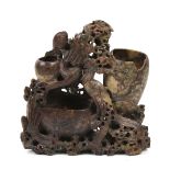 A Chinese soapstone water pot. Carved with a phoenix and dragon and three variously sized pots.