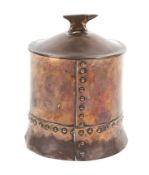 A circa 1900 Arts and Crafts blacksmith's cylindrical tobacco jar.
