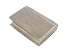 An 1862 brass novelty snuff box in the form of a small brass book.