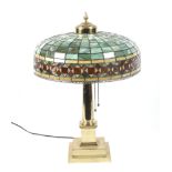 A 1922 gilded Tiffany style table lamp.
