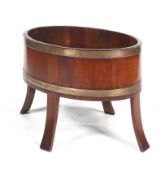 A late Victorian mahogany and brass banded staved/coopered oval planter.
