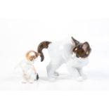Two ceramic models of cats.