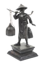 A bronze sculpture of a Chinese female watercarrier.