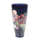 A Moorcroft vase, of tapered form, glazed blue with the Anemone pattern.