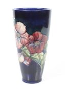 A Moorcroft vase, of tapered form, glazed blue with the Anemone pattern.