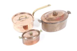 A copper lidded saucepan and two oval pans.