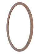 A circa 1910 oval plannished copper framed wall mirror.