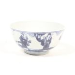 A 19th century blue and white bowl decorated with three scholars beneath a prunus. Diameter 11.
