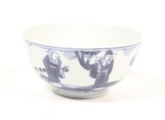 A 19th century blue and white bowl decorated with three scholars beneath a prunus. Diameter 11.