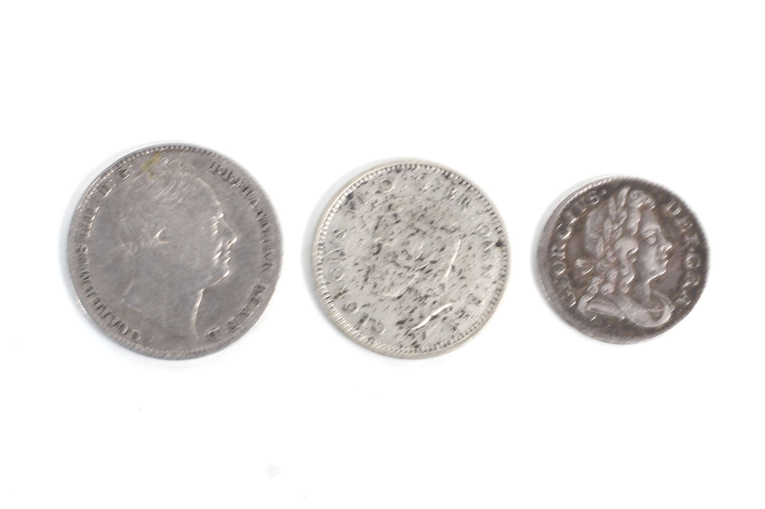 Three small silver coins: Two maundy coins: 1717 two pence and 1836 four pence,