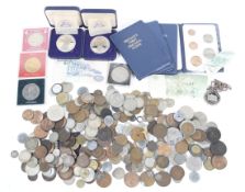 A tin of world coins including some silver.