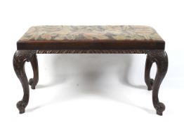 A 19th century mahogany fender stool. With tapestry drop in set over carved cabriole legs.