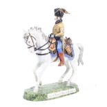 A 20th century hand painted porcelain sculpture of a soldier on horseback.