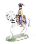 A 20th century hand painted porcelain sculpture of a soldier on horseback.