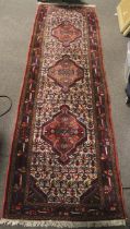 An early -mid 20 th century woollen Runner carpet / rug with geometric medallions,
