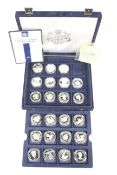 23 silver crown size world coins. In a blue case with certificates.