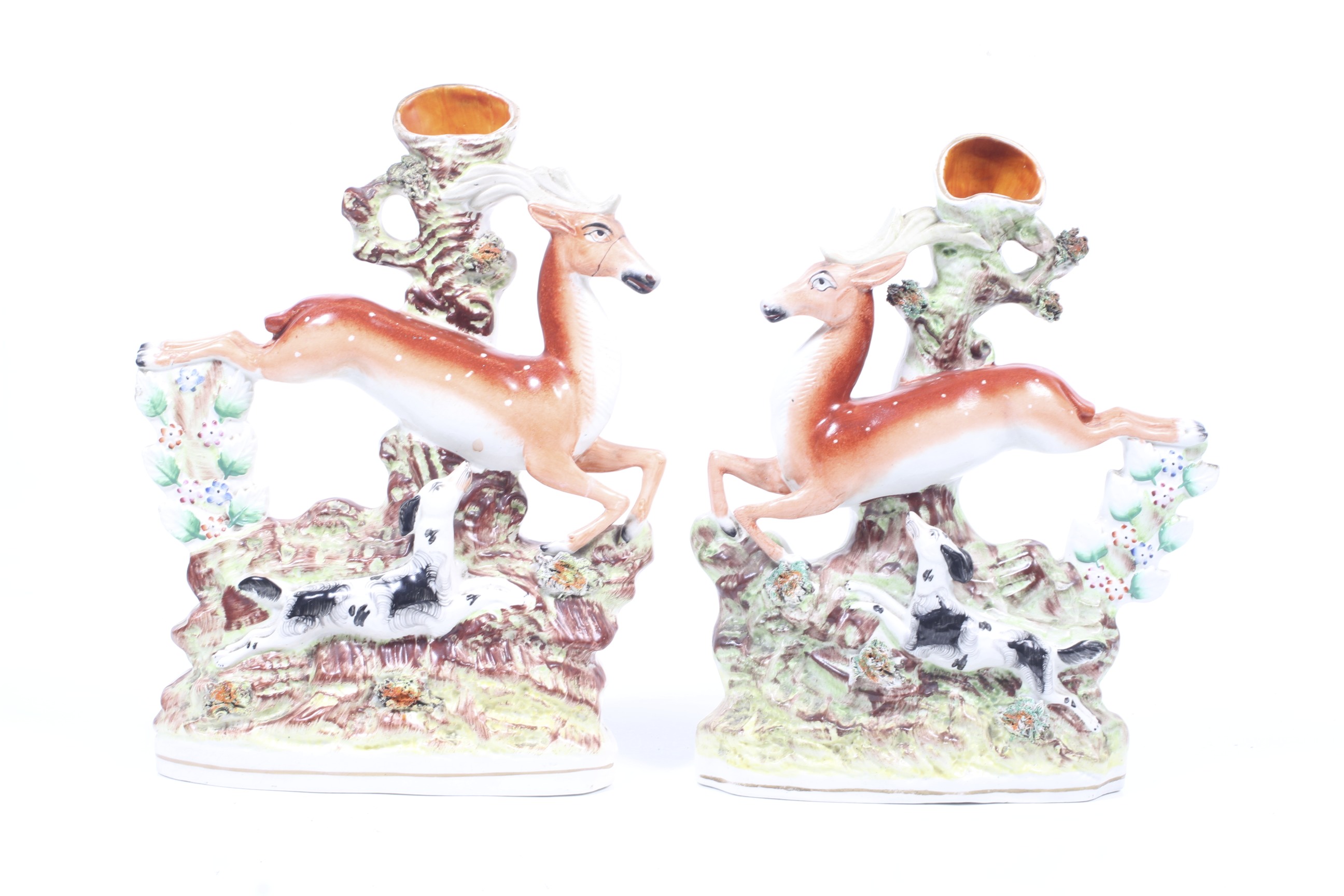A pair of 19th century Staffordshire stag spill vases.