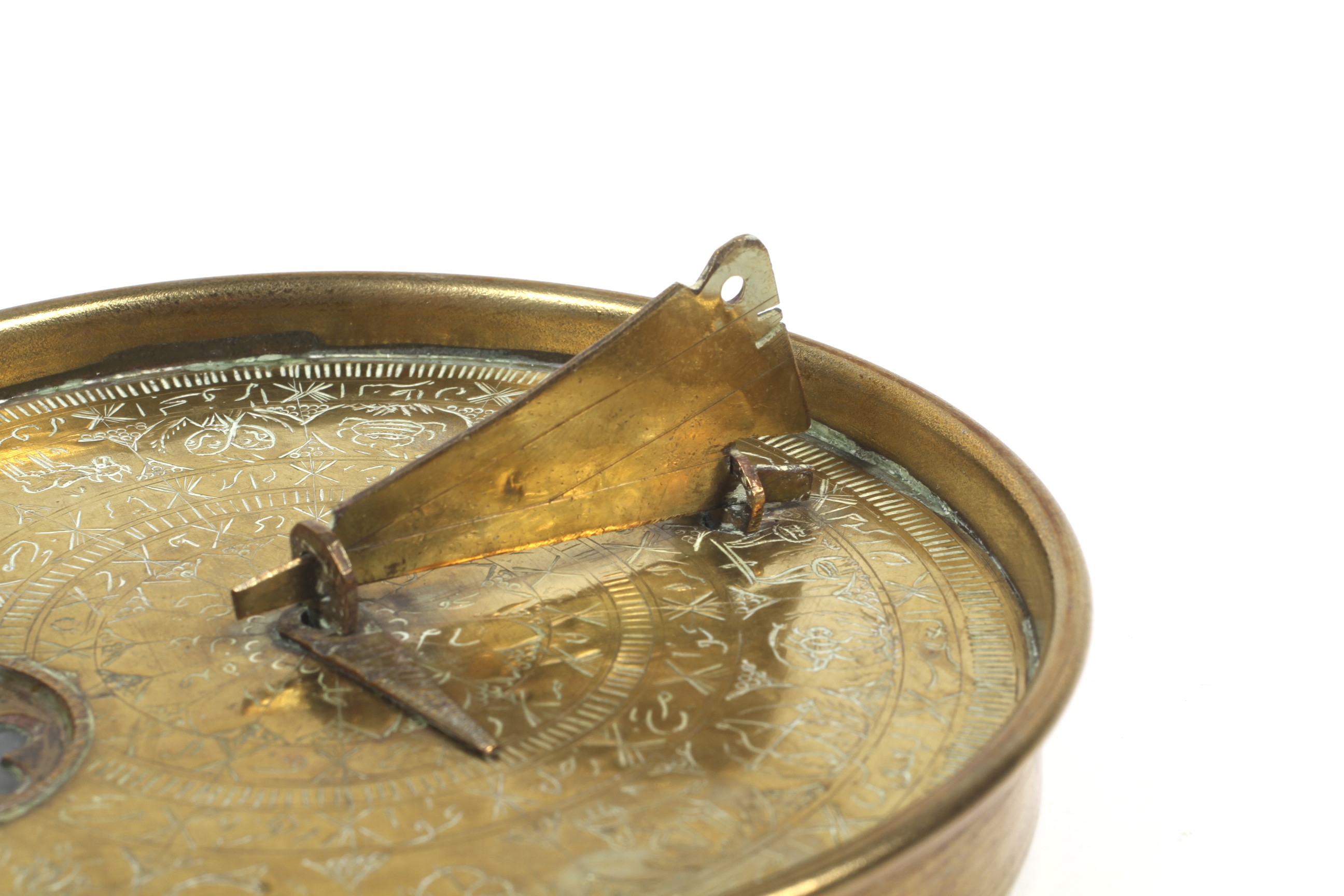 A brass Islamic sundial. Engraved with concentric borders including one with signs of the zodiac. - Image 2 of 2