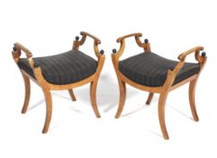 A pair of circa 1900 Biedermier satinwood and ebonised upholstered stools.