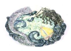 A hand painted oval relief plate with mermaid and boat at sea.