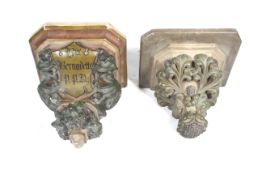 Two painted plaster wall brackets from a Belgian church.